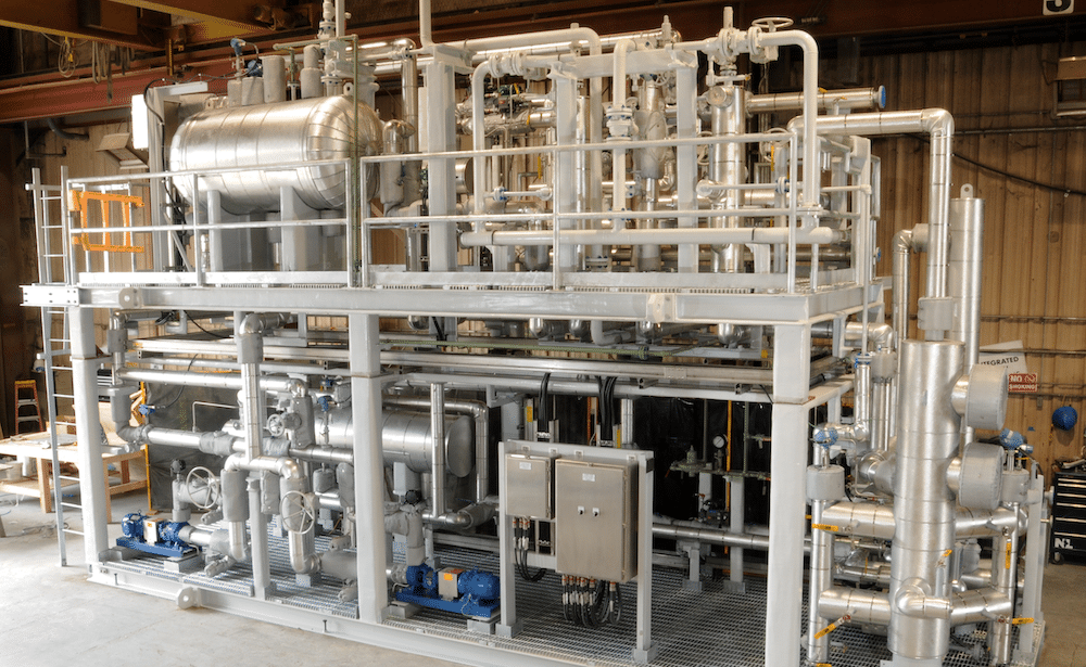 IFS/DXP ethane heater skid with insulated piping, pumps, valves, and control panels.